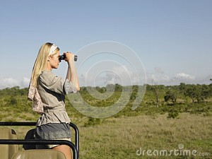 blond-woman-looking-binoculars-jeep-side-view-young-safari-standing-33900615